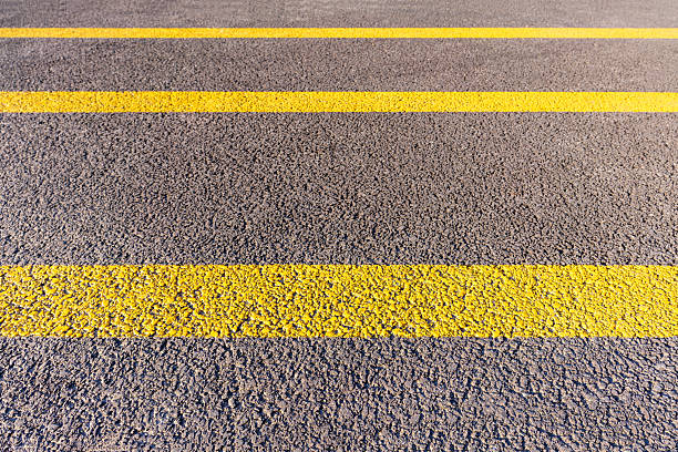 Asphalt road with yellow line background.