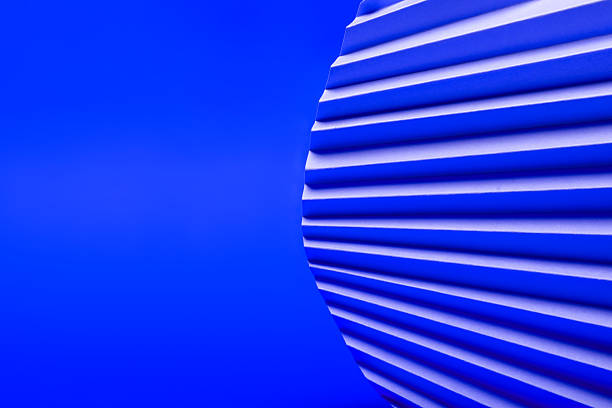 Abstract background with a circular shape of wavy lines in shades of blue on a solid blue background