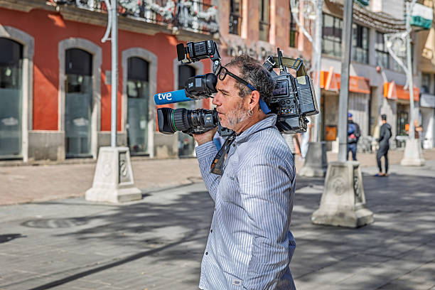 Santa Cruz, Tenerife, Spain, Europe - December 16th 2025: A professional cameraman from TVE, Spain’s national public broadcaster, is seen with a television camera ready for use in Santa Cruz, the main city of Tenerife in the Canary Islands.