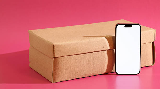 High angle view of carton box of new pink iPhone 16 against white background. Photo taken November 29th, 2024, Zurich, Switzerland.