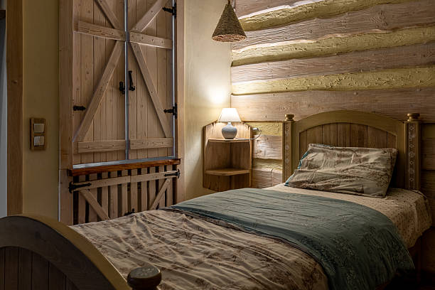 Digitally generated image of bedroom interior in a winter cottage. Beautiful interior of bedroom in a wooden log bedroom in 3d.