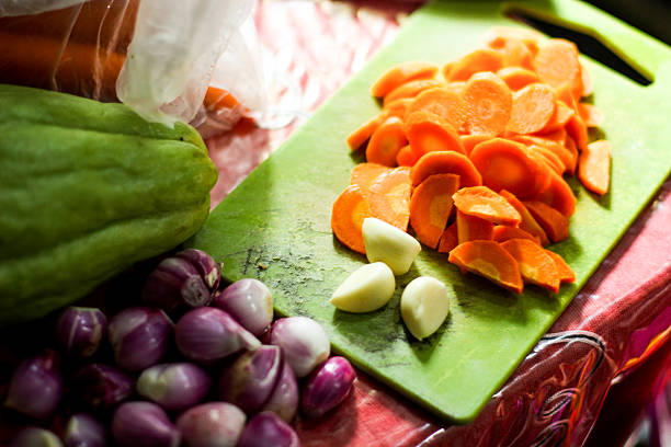 carrots, garlic and shallots on a cutting board