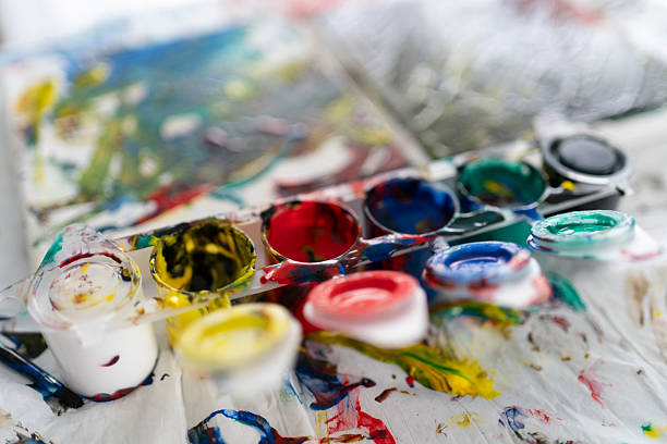 Baby paints on the table background