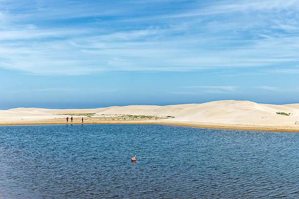 istock Three fishermen walking around lagoon 2256586514