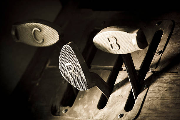 Authentic foot pedals from a classic car from the 1910s or 1920s. Look at the oldfashioned handmade craftmansship. The Clutch, Reverse and Break signs were clearly visible on the pedal.