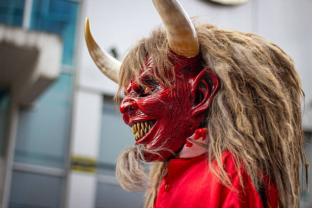Krampus mask featuring red skin, fierce expression, wild hair, and large horns, representing the popular alpine folklore tradition associated with saint nicholas