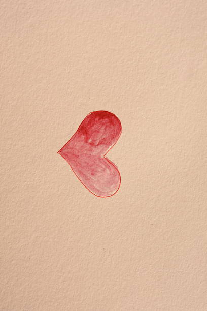 On a black background there is a wooden Christmas figure in the shape of a red heart with white polka dots. It is on one side leaving enough space to write the desired Christmas text. Part of a series