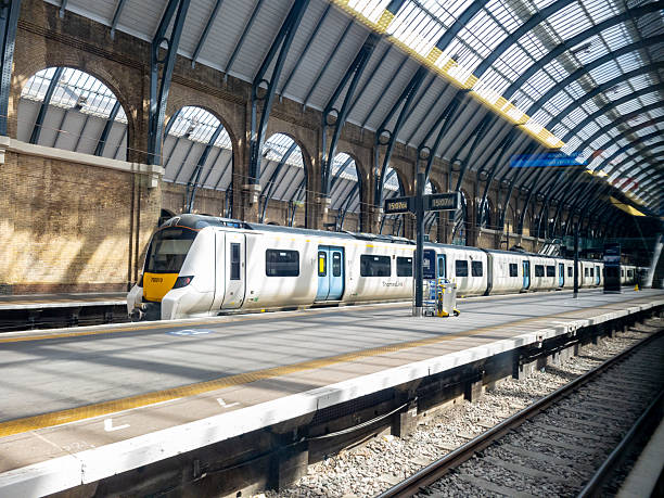 London, England - August 2021: Passengers arriving at London Paddington railway station. A Great Western Railway high speed train is alongside the platform