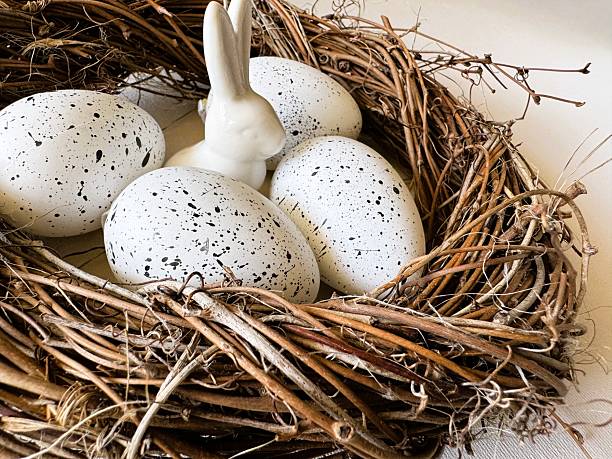 Macro view of a holiday arrangement with a bunny and white eggs, representing the joy of Easter (Ostern). High-quality printing, festive posters, and home decor catalog illustrations.
