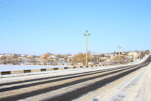 A road with snow on the side. Sky. Outdoor. Track. Scene. Way