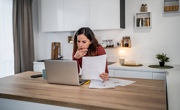 istock Woman calculating home finances and managing budget 2256602091