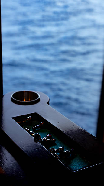 Chess board with pieces resting by a window overlooking the blue ocean