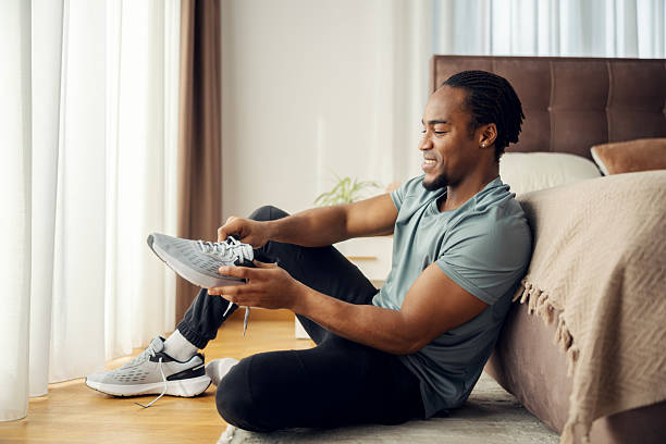 istock Young man tying running shoes getting ready for workout 2256613811