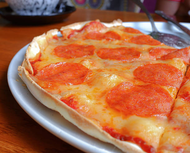 selective focus. pizza on a white platter and a wooden table in a cafe. rest and travel
