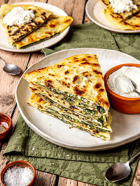 Sliced and stacked Turkish flatbread with spinach and cheese