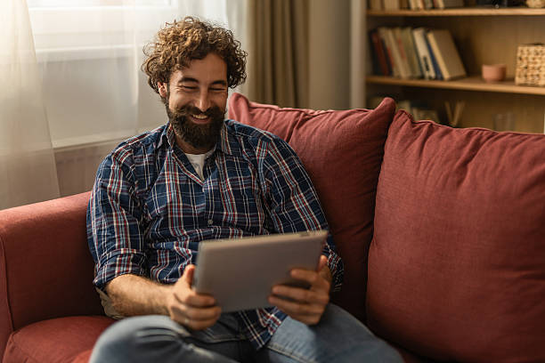 istock Young man enjoying streaming content on digital tablet 2256623147
