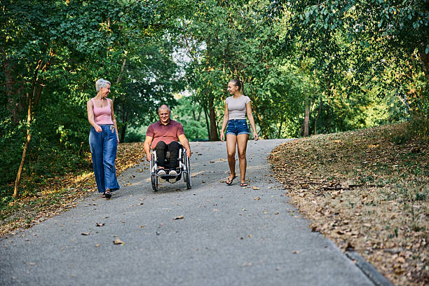 istock Group Outdoor Stroll With Wheelchair Accessibility in Park 2256626016