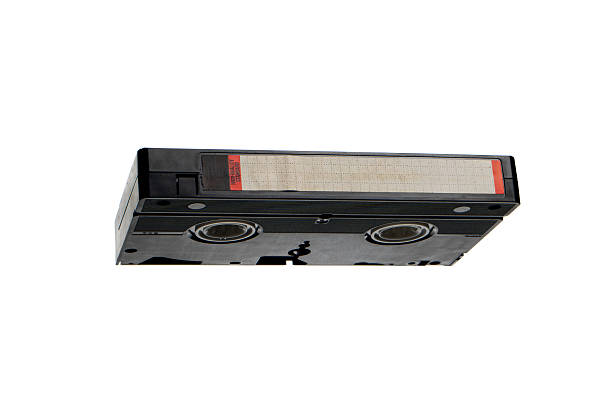 Vintage black VHS video cassette with blank label isolated on a white background.