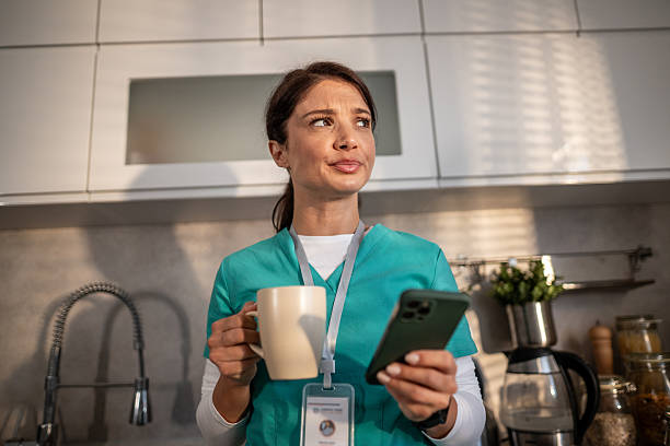 istock Healthcare worker relaxing at home while using smartphone 2256642653