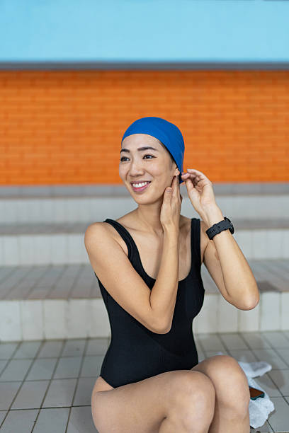 Woman swimmer preparing for training at swimming pool