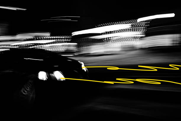 Design element  : Car in blurred motion. This abstract nighttime photo, shot with a monochrome sensor, captures a car’s speed in total darkness. Deep black dominates, revealing only a blurred vehicle silhouette and, above all, the headlight trails turned into vivid, twisting yellow serpents via a yellow filter . The extreme motion blur and striking yellow-on-black contrast evoke raw energy, urgency, and a hint of lurking danger. Technically bold, the image symbolizes our reliance on fragile artificial light to progress through the unknown — a mix of hope and the risk of rushing too fast. A powerful artistic choice that makes the work hypnotic and unforgettable.► Authentic photography by Pictore, free of artificial intelligence