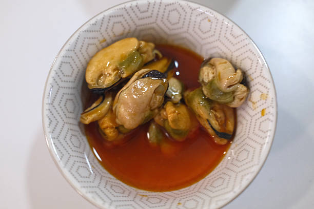 Fresh steamed mussels served in shell with broth or lemon.