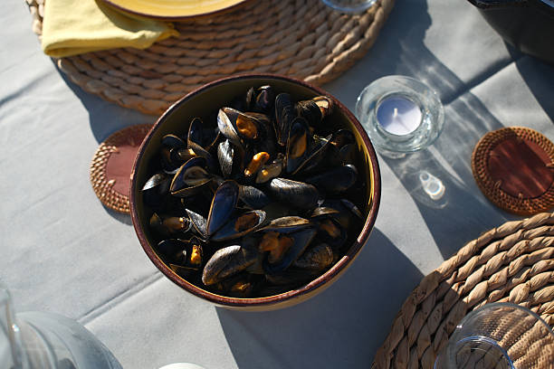 Fresh steamed mussels served in shell with broth or lemon.