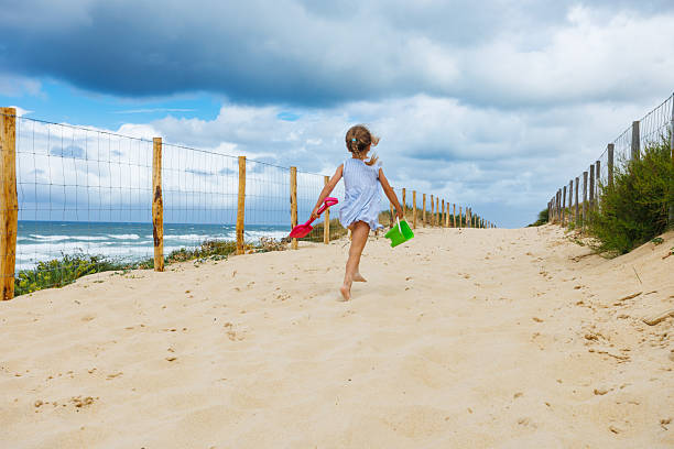 Happy children kid enjoy and fun outdoor lifestyle travel nature at the sea on summer beach holiday vacation. Portrait of Little cute child boy in swimwear relaxing on the beach in summer sunny day.