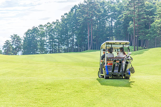 Valmiera, Latvia - October 18, 2024 - A golf cart parked on a frosty golf course at sunrise, with golden light casting long shadows across the grassy landscape.