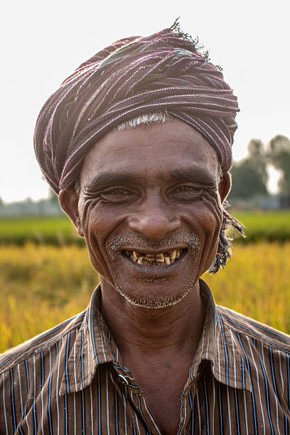 A farmer smiling by looking at camera