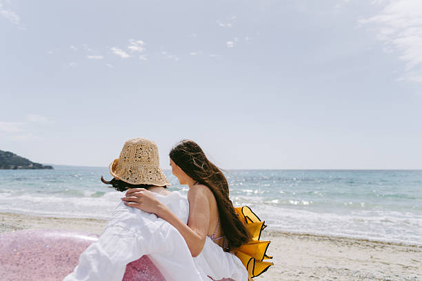 Photo of a couple of young women on their way to the local beach