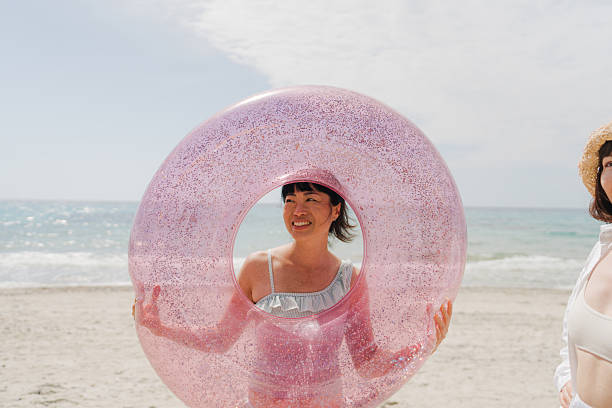 Photo of a couple of young women spending fun afternoon on the local beach