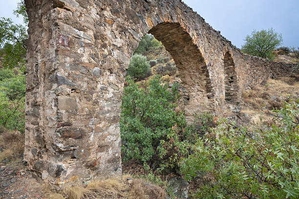 Ancient aqueduct on Greek Island of Chios on an overcast day in late summer or early fall (October). The aqueduct is called Maiden’s bridge and was possibly built during the Roman or Byzantine era. The image was captured with a full frame mirrorless digital camera and a sharp lens at low ISO resulting in a large image file suitable for large prints. The image is part of a large series of photographs of architecture and landscapes on Chios captured at different seasons during many years.