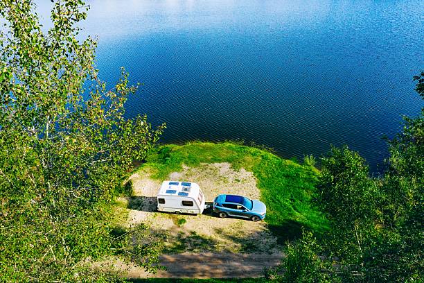 Exploring Nature: Serene Lakeside Camping Adventure with a Caravan and Car