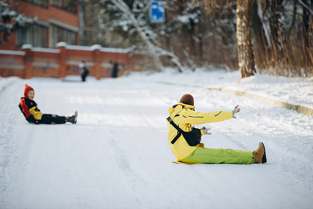 Happy children sledding down snowy hills in a picturesque forest, celebrating winter holidays with laughter and joy in the crisp air