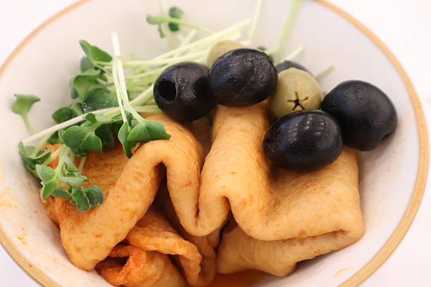 A bowl composed of my own flavor stuffs at a buffet restaurant : It is a fusion-style dish that is differentiated from typical fish cake dishes, with black and green olives and sprouts as garnish.