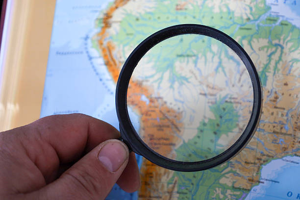 A magnifying glass focusing on California on a map