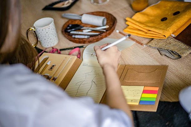 Independent fashion designer sketching new collection ideas
