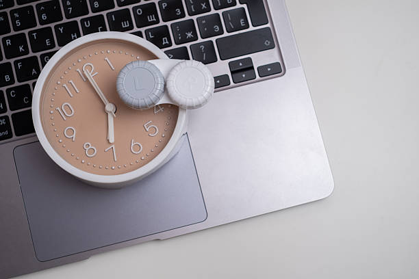 Contact lens container on laptop keyboard during work routine. Office vision care concept.
