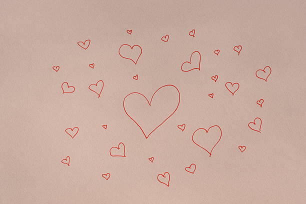 Large red heart in the center on white paper, surrounded by many smaller hearts of different sizes, drawn with a pen.