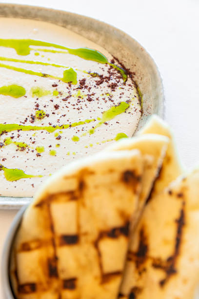 Arabic labaneh hummus cream dip with thyme oil and roast bread served at Middle Eastern restaurant