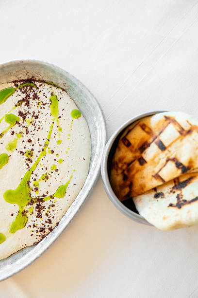 Arabic labaneh hummus cream dip with thyme oil and roast bread served at Middle Eastern restaurant