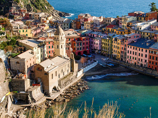 Vernazza, Italy: ancient village on the eastern Ligurian coast. Colored houses surround the small marina. The Doria Castle is a medieval defensive structure with a cylindrical tower.