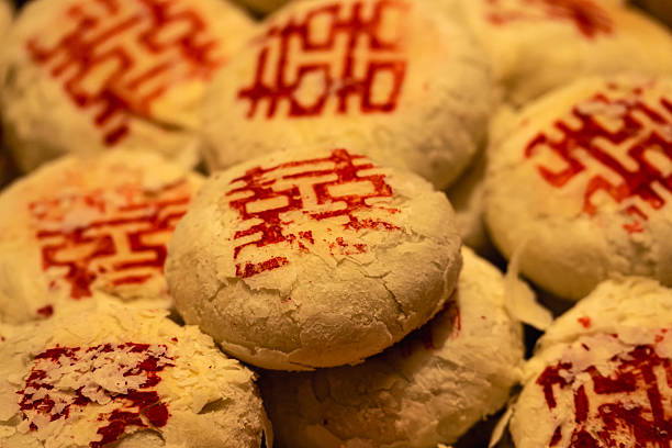 A round, traditional Chinese New Year pastry is stamped with a large red \