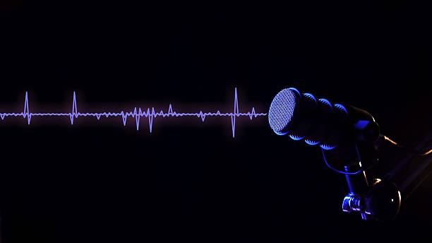 istock Studio microphone with neon blue wave line on a dark background for podcasts 2256756223