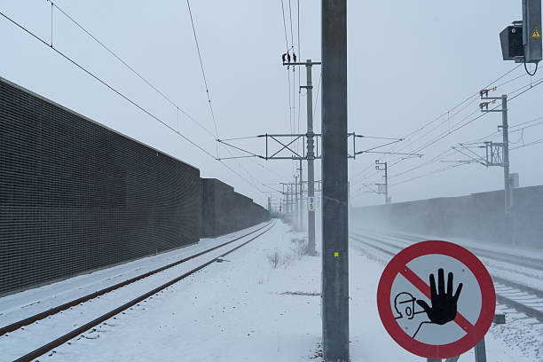 stop sign on end of the platform of rural railway station on cold snowy icy winter day