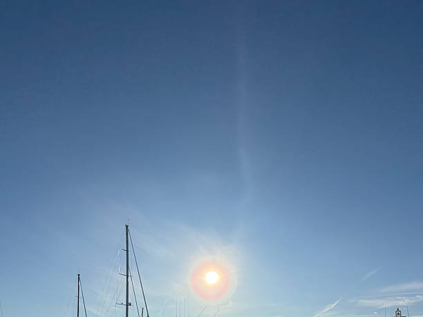 Sun on a clear day over some boats