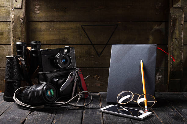 Low key still life composition with a military green crate in the background, retro and documentary mood.