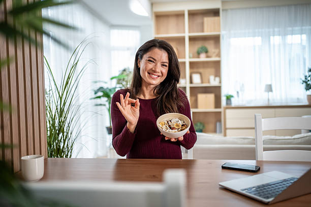 Woman enjoying healthy breakfast bowl showing ok gesture