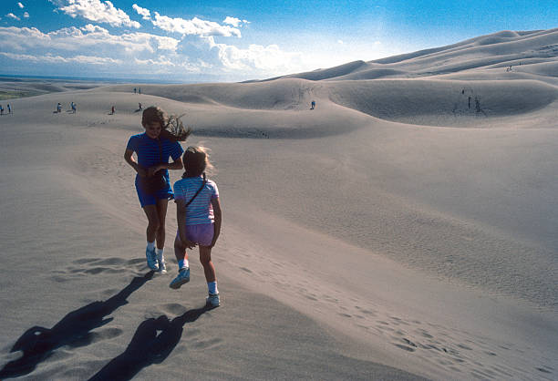 Great Sand Dunes National Park - Sisters run on the sand - 1990. Scanned from Kodachrome 64 slide.